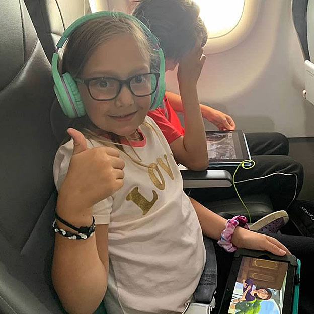 kids flying on frontier airplane