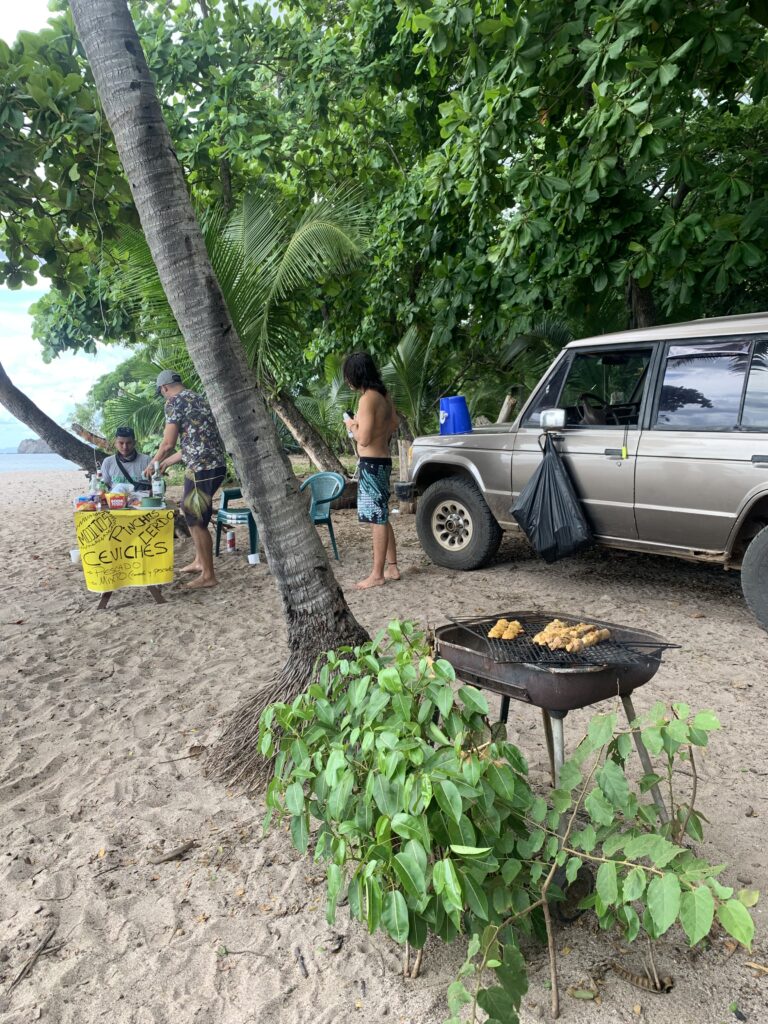 Ticos grilling food on the beach